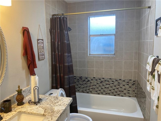 bathroom featuring toilet, vanity, and shower / bath combo