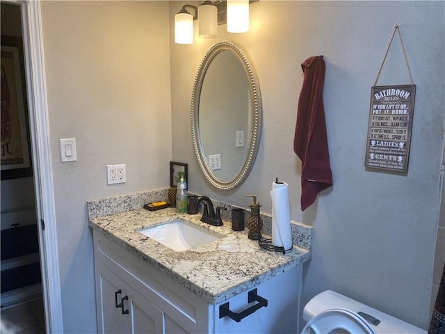 half bathroom featuring toilet and vanity