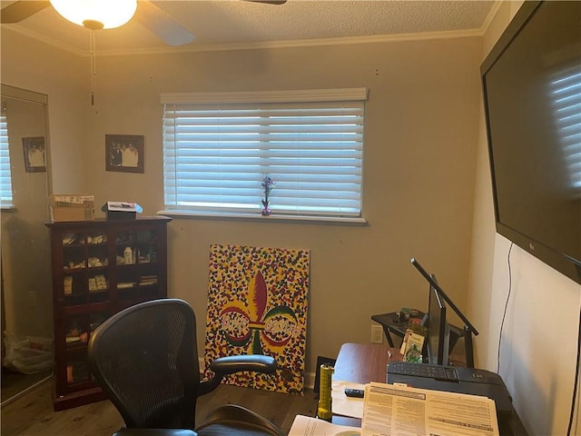 home office featuring a textured ceiling, ceiling fan, wood finished floors, and ornamental molding