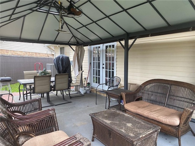 view of patio / terrace featuring a gazebo, outdoor dining area, and french doors