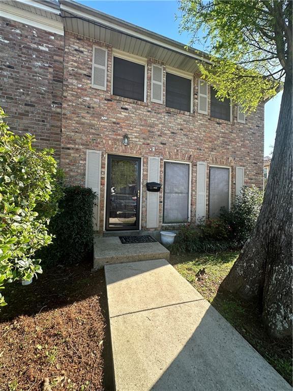 view of front of home featuring brick siding