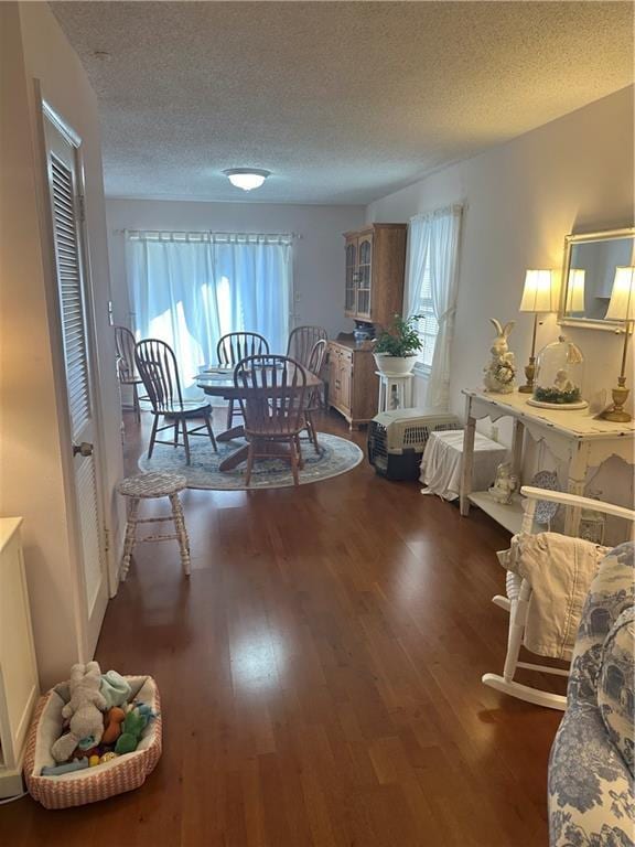 dining area with wood finished floors and a textured ceiling