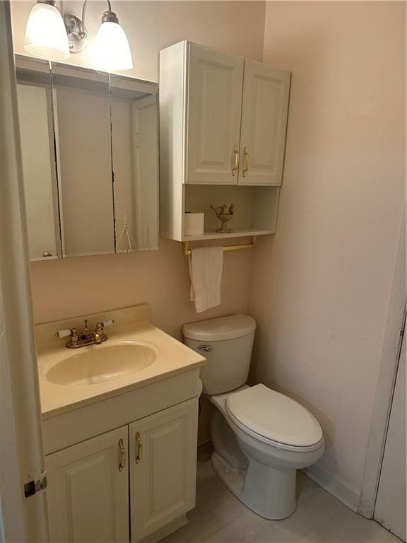 half bathroom featuring toilet and vanity