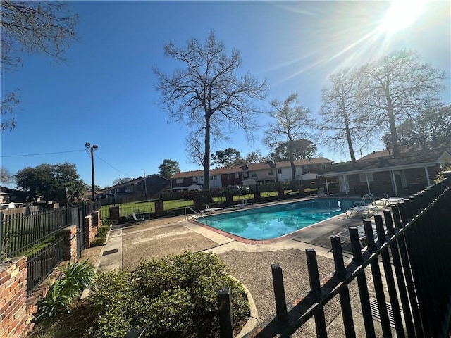 community pool featuring a patio area and fence