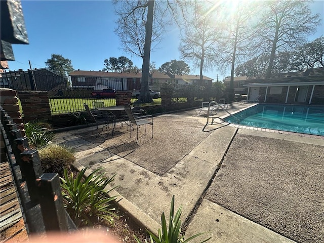 view of pool featuring a fenced in pool, fence, and a patio area