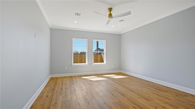 empty room featuring light wood-type flooring, crown molding, baseboards, and a ceiling fan