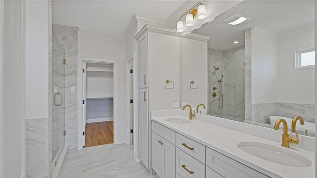 full bath with a shower stall, crown molding, and a sink