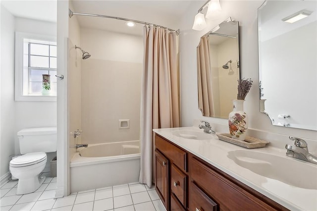 bathroom featuring tile patterned flooring, shower / tub combo, toilet, and a sink