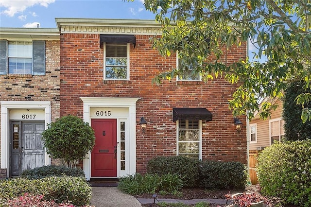 townhome / multi-family property featuring brick siding