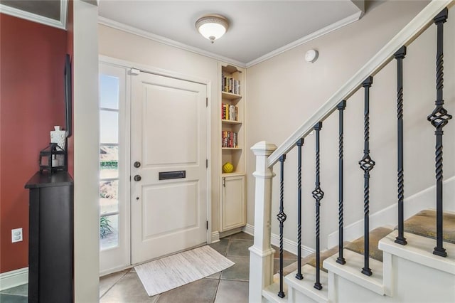 tiled foyer featuring stairs and crown molding