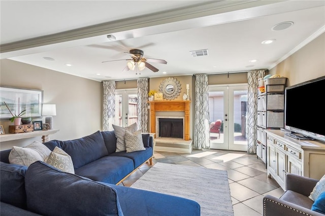 living area featuring light tile patterned floors, french doors, visible vents, and a wealth of natural light