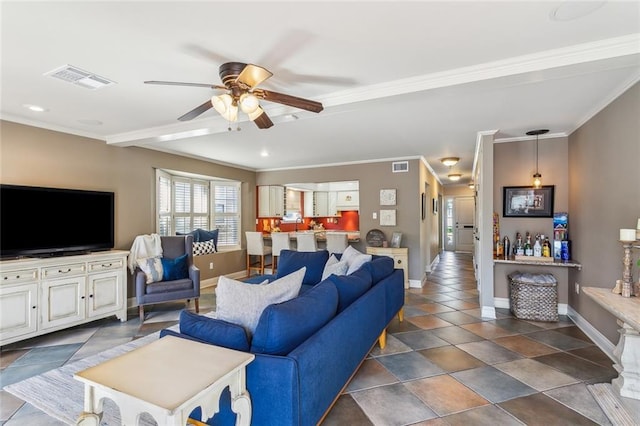 living area with visible vents, baseboards, and ornamental molding