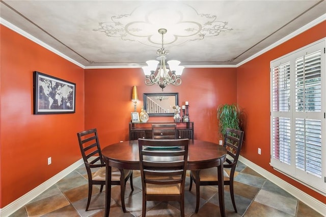 dining room featuring a notable chandelier, baseboards, and ornamental molding