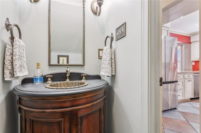 bathroom featuring tile patterned floors, vanity, and crown molding