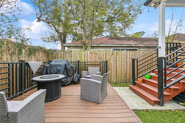 deck with area for grilling and a fenced backyard