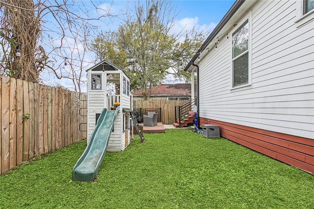 view of yard featuring a playground and a fenced backyard