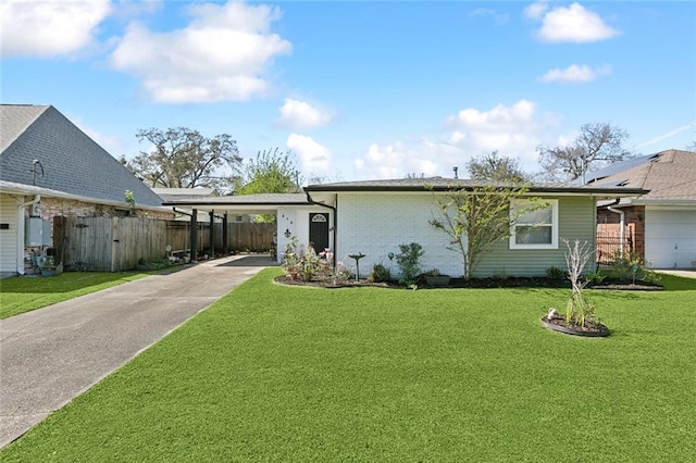 view of front of property with an attached carport, a front yard, fence, concrete driveway, and brick siding