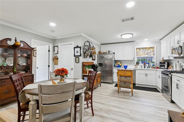 kitchen featuring visible vents, appliances with stainless steel finishes, and crown molding