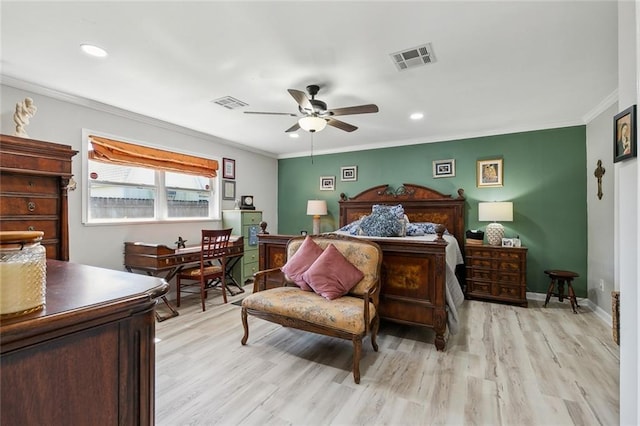 bedroom featuring visible vents, crown molding, and light wood-style floors