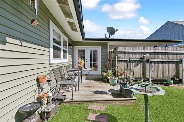 wooden deck featuring french doors, fence, and a lawn