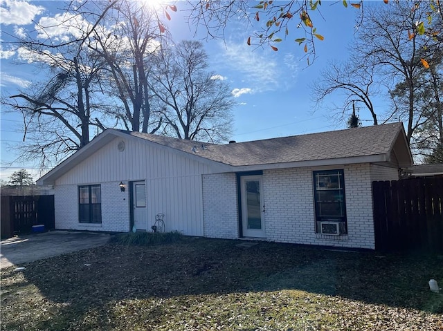 single story home featuring a patio, brick siding, and fence