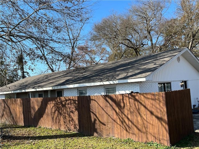 exterior space with brick siding and fence