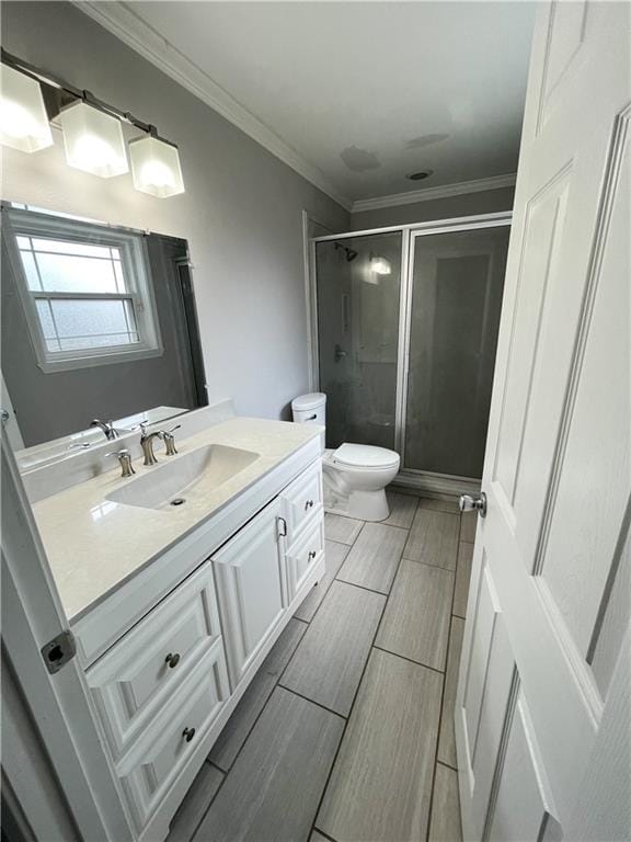 full bathroom featuring toilet, ornamental molding, vanity, a shower stall, and wood tiled floor