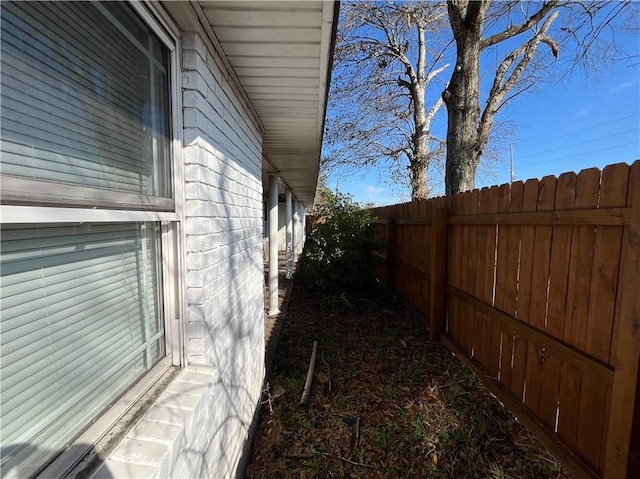 view of side of property featuring fence