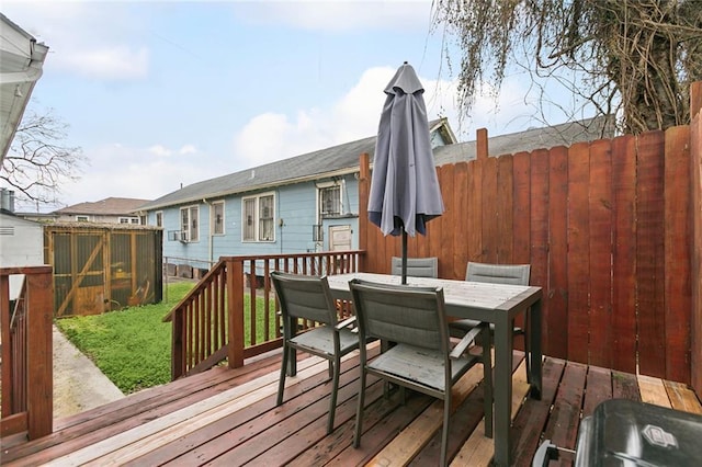 wooden terrace featuring outdoor dining space and fence