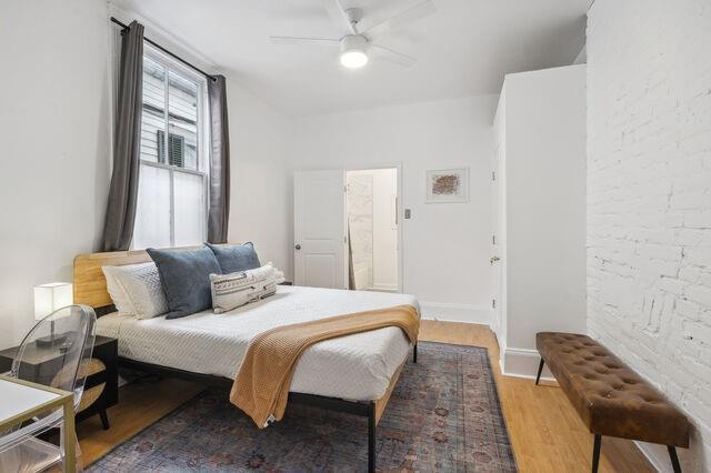 bedroom featuring baseboards, light wood-type flooring, and ceiling fan