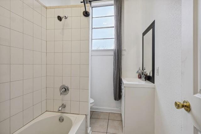 bathroom featuring tile patterned floors, shower / tub combination, toilet, and vanity