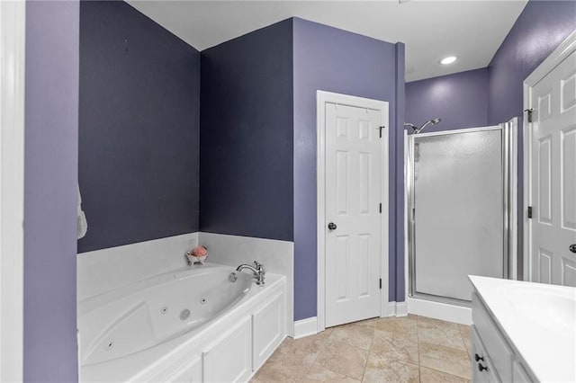 full bath featuring vanity, a shower stall, a tub with jets, and baseboards