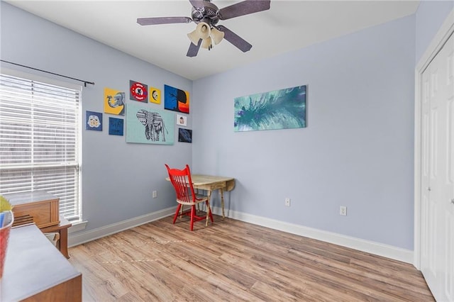 rec room with a ceiling fan, baseboards, and light wood-type flooring