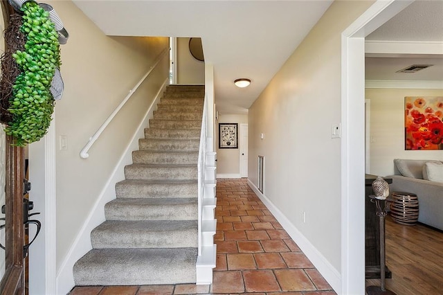 staircase featuring visible vents and baseboards