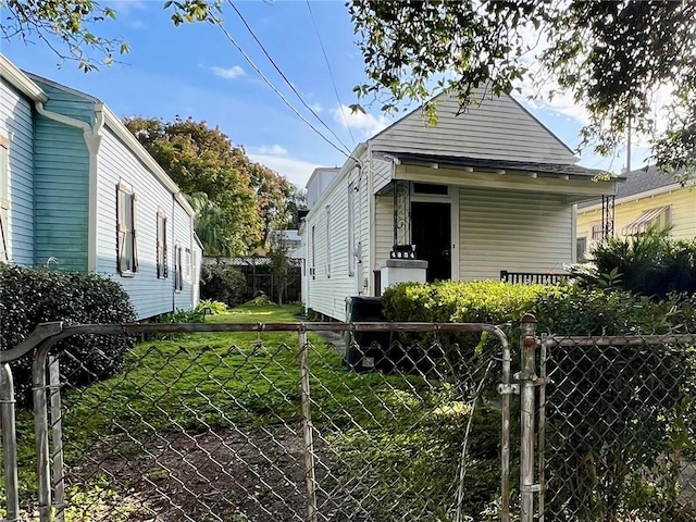 shotgun-style home with fence private yard and a front lawn