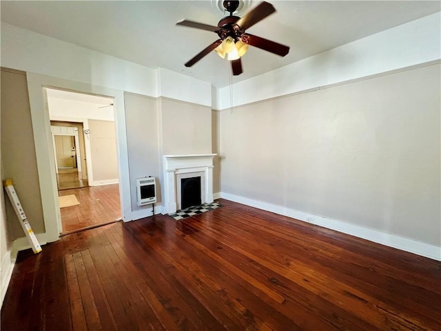 unfurnished living room with heating unit, baseboards, a fireplace with flush hearth, ceiling fan, and dark wood-type flooring