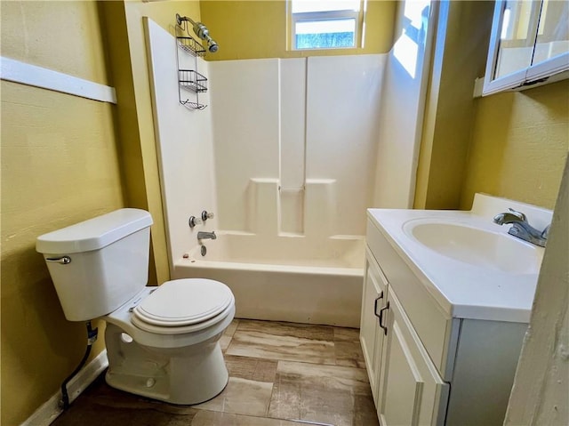 bathroom with vanity, shower / tub combination, and toilet