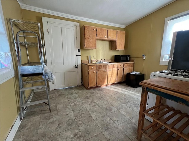 kitchen featuring crown molding, brown cabinets, black microwave, and a sink