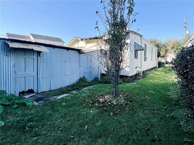 view of property exterior featuring an outbuilding and a lawn