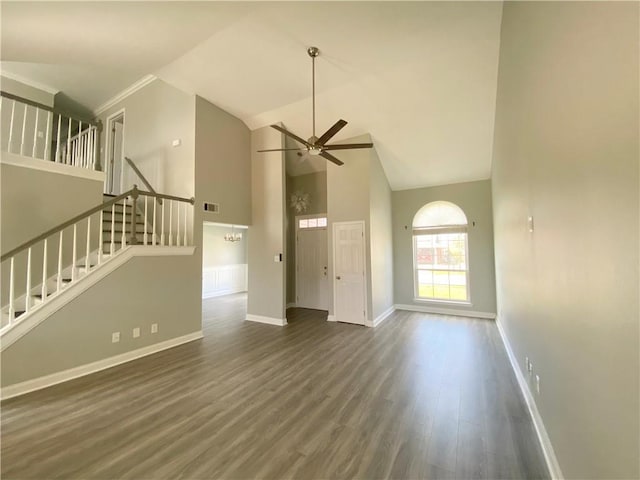 unfurnished living room featuring visible vents, high vaulted ceiling, wood finished floors, stairway, and ceiling fan