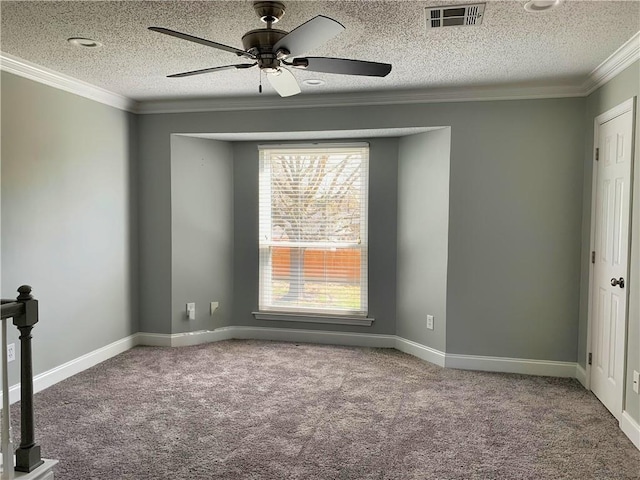 empty room with baseboards, carpet, visible vents, and ornamental molding