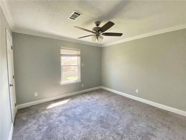 carpeted spare room with visible vents, baseboards, a textured ceiling, and ornamental molding