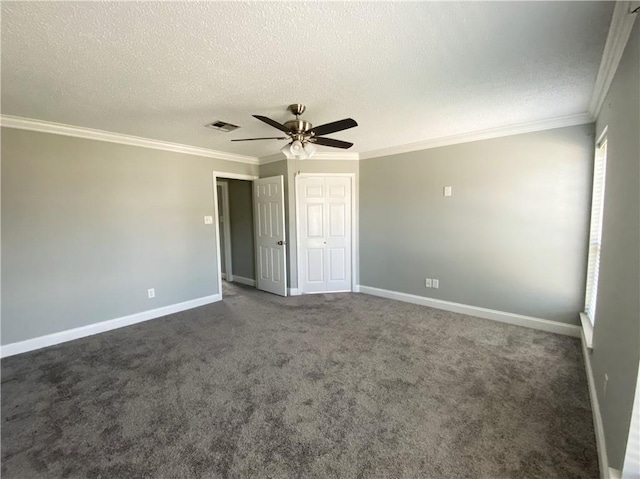 spare room with visible vents, a textured ceiling, crown molding, baseboards, and ceiling fan