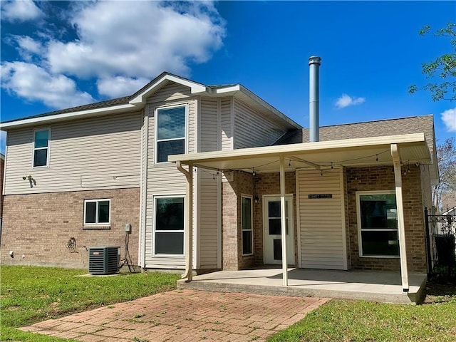 back of house with brick siding, central AC, and a patio area