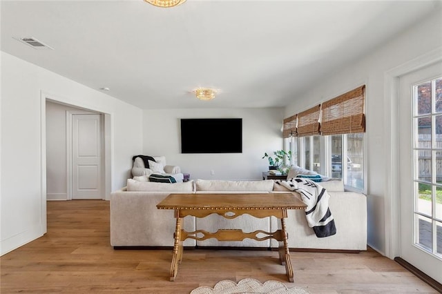 living area with plenty of natural light and wood finished floors