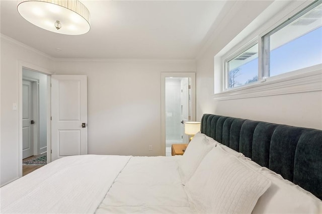 bedroom featuring connected bathroom and crown molding