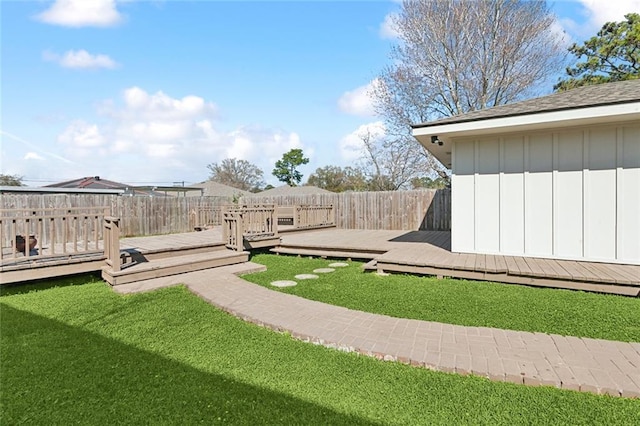 view of yard with a deck and a fenced backyard