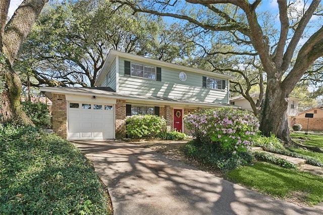 view of front of house featuring an attached garage, brick siding, and driveway