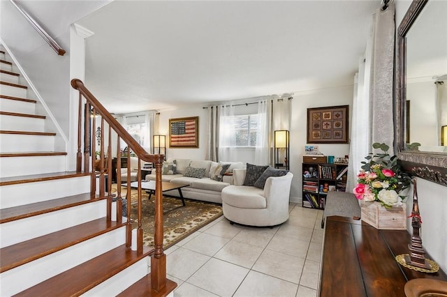 living area featuring light tile patterned flooring and stairs