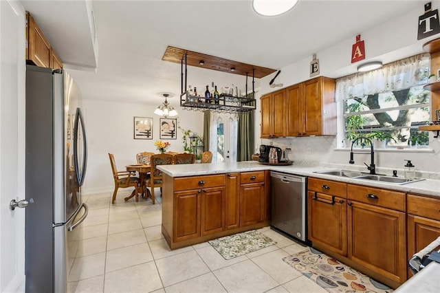 kitchen featuring brown cabinets, appliances with stainless steel finishes, and a sink